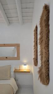 a bedroom with a bed and furry items on the wall at Casa do Castelo Terena in Alandroal