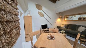 a living room with a table and a couch at Casa do Castelo Terena in Alandroal