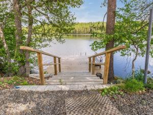 a wooden bridge over a body of water at Holiday Home Hankamaja by Interhome in Ihamaniemi