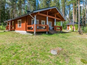 a small cabin in the woods with a grassy field at Holiday Home Hankamaja by Interhome in Ihamaniemi