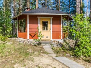 a small house in the middle of a forest at Holiday Home Hankamaja by Interhome in Ihamaniemi