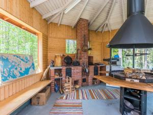 a room with wooden walls and a large window at Holiday Home Hankamaja by Interhome in Ihamaniemi +26 photos