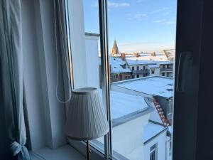 a room with a window with a view of a city at Luisen City Studio Görlitz in Görlitz