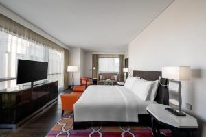 a hotel room with a large bed and a television at Rotana Jabal Omar Makkah in Mecca
