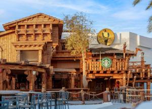 a large wooden building with tables and chairs at JAZ Sharm Dreams in Sharm El Sheikh