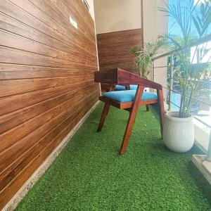a chair sitting on a green rug next to a wall at hotel Atithii in Rīngas
