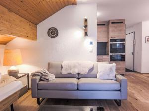 a living room with a couch and a kitchen at Apartment Eiger Residence Apt-A-425 by Interhome in Wengen