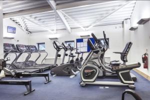 a gym with cardio machines and treadmills at Apollo Hotel in Basingstoke +40 photos