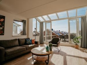 a living room with a couch and a table at Apartment Oostergeest by Interhome in Uitgeest