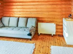 a living room with a couch and a heater at Holiday Home Sillankorva by Interhome in Korpijärvi