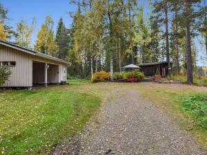 a dirt road next to a building and a gazebo at Holiday Home Mykkylä by Interhome in Niemi