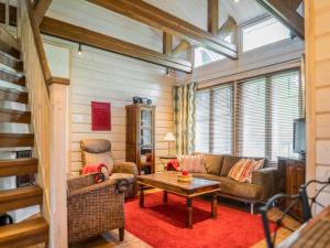 a living room with a couch and a table at Holiday Home Asterix by Interhome in Tahkovuori