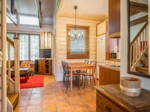 a kitchen and dining room with a table and chairs at Holiday Home Asterix by Interhome in Tahkovuori
