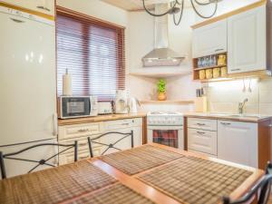 a small kitchen with a table and a microwave at Holiday Home Asterix by Interhome in Tahkovuori +13 photos