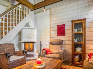 a living room with a table and a fireplace at Holiday Home Asterix by Interhome in Tahkovuori