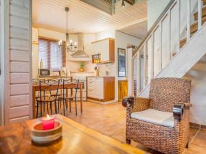 a kitchen and living room with a table and chairs at Holiday Home Asterix by Interhome in Tahkovuori