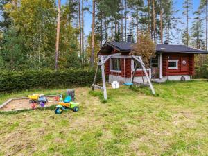 a small cabin with toys in front of it at Holiday Home Honkalinna by Interhome in Kokkosenlahti