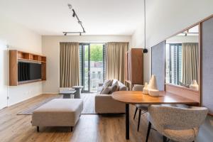 a living room with a dining room table and a couch at Utrecht City Apartments - Huizingalaan in Utrecht