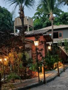 a guest house at night with palm trees and lights at Espaço Casa Palmar in Barra Grande +42 photos