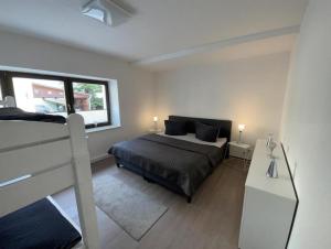 a bedroom with a bed and a window at Fewos4seasons in Kurort Oberwiesenthal