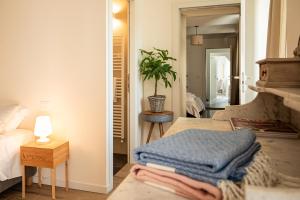 a bedroom with a bed and a table with towels at Tenuta Dei Vicini - Luxury Apartments in San Marzano Oliveto +49 photos