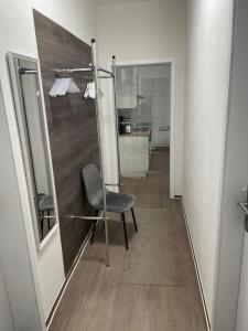 a chair sitting in a hallway with a mirror at Fewos4seasons in Kurort Oberwiesenthal