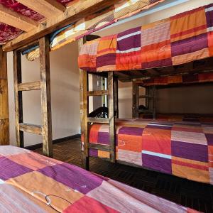 two bunk beds in a room with wooden ceilings at Bolivian Heights Hostel in La Paz