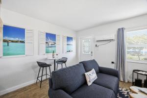 a living room with a couch and a table at 107 · Boat dock- BBQ Walk to Beach GREAT VIEWS in St. Pete Beach