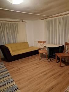 a room with a bed and a table and chairs at Augšistaba Beči in Vecumnieki