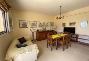 a living room with a table and a couch at Suli Residences in Pesádha