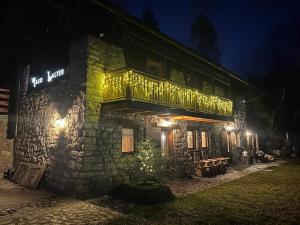 a stone building with lights on it at night at Maso Walter in Pradellan