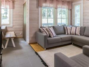 a living room with a couch and some windows at Holiday Home Sini 2b by Interhome in Lahdenperä +23 photos