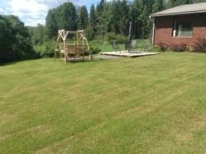 a yard with a playground in the middle of a field at Holiday Home Jokela by Interhome in Horonkylä +25 photos