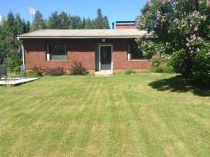 a brick house with a large yard in front of it at Holiday Home Jokela by Interhome in Horonkylä