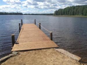 a wooden dock in the middle of a lake at Holiday Home Jokela by Interhome in Horonkylä