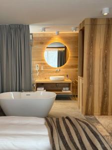a bathroom with a white tub and a sink at Nova Hill in Zakopane