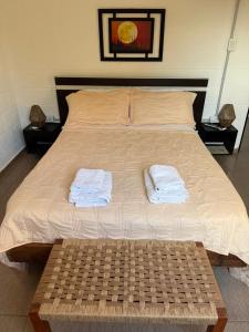 a bed with two towels sitting on top of it at Tres Soles in Salsipuedes +18 photos