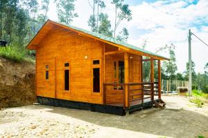 a small wooden cabin with a metal roof at Cabañas Tierra Noble in Nobsa