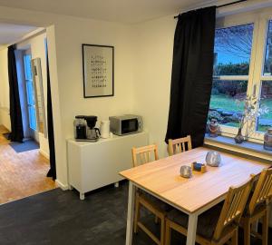a dining room with a table and a microwave at Ferienwohnung Engels in Olpe