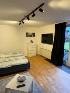 a bedroom with a bed and a tv and a table at Ferienwohnung Engels in Olpe