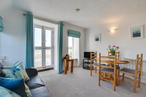 a living room with a table and chairs and a couch at 1 Bed in St. Ives oc-pc716a in St Ives