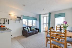a kitchen and living room with a table and a couch at 1 Bed in St. Ives oc-pc716a in St Ives