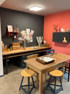 a room with a table and two stools and a desk at Gastwerk Waldfrieden in Gießen
