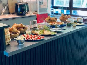 a buffet line with plates of food and pastries at Gastwerk Waldfrieden in Gießen