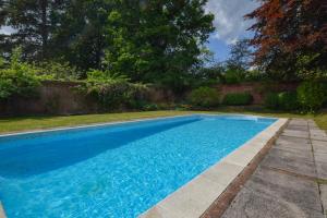 a swimming pool with blue water in a yard at 2 Bed in Landford oc-l31877 in Landford