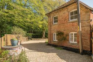 a brick house with a fence and a yard at 2 Bed in Landford oc-l31877 in Landford
