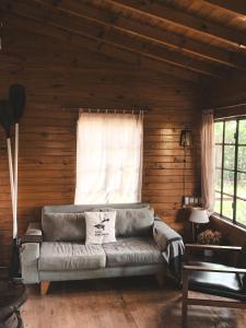 a living room with a couch in front of a window at Casa Chichipio in Tigre