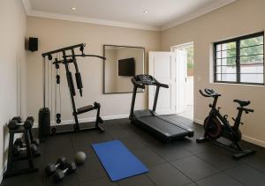 a gym with three exercise bikes and a mirror at The White House at Plattekloof in Plattekloof