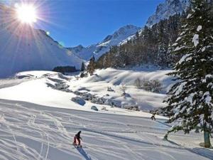 two people are skiing down a snow covered slope at Appartement cosy 5 pers, 1 ch, parking couvert, accès pistes, centre station - FR-1-404-57 in La Mongie +7 photos