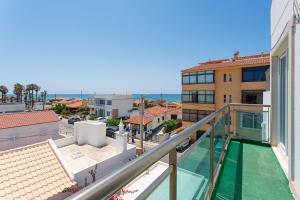 a balcony with a view of the ocean from a building at Blife Charlya private rooms at Faro beach in FAO +29 photos